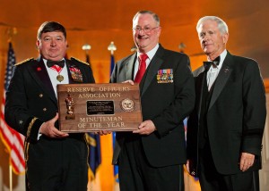 Arnold Punaro (center) accepts the Minuteman of the Year Award on March 4, 2014